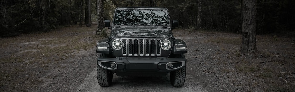 Black Jeep SUV parked on forest | Breast Cancer Car Donations