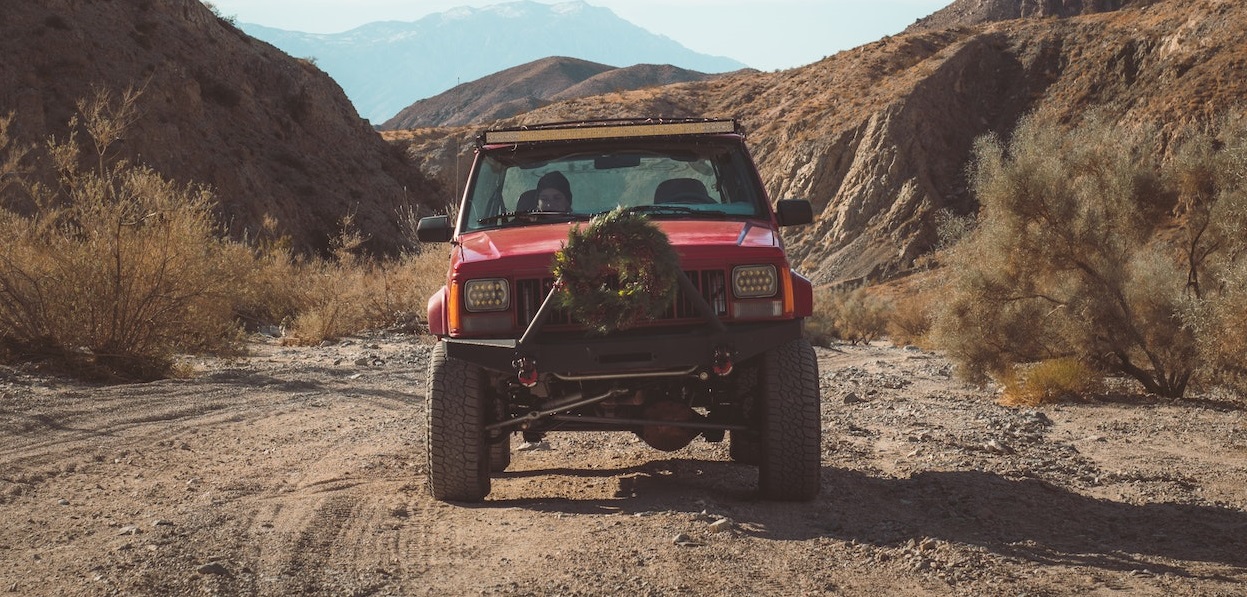 Red Jeep SUV parked on dirty | Breast Cancer Car Donations