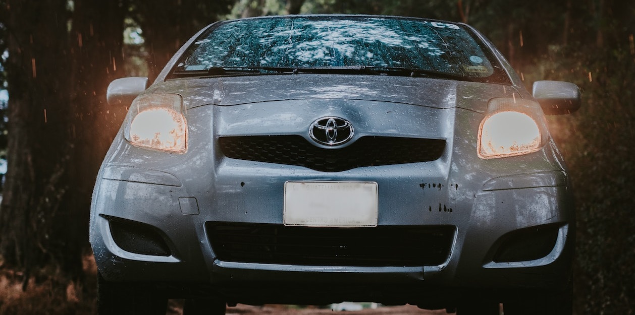 Silver sedan parked near trees | Breast Cancer Car Donations