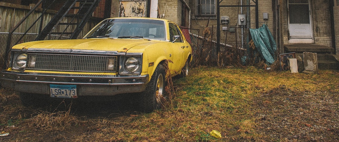 Yellow car parked outside house | Breast Cancer Car Donations