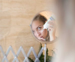 Woman Looking in the Mirror | Breast Cancer Car Donations