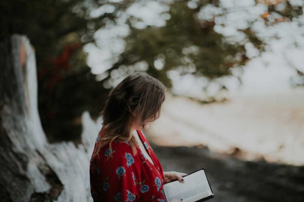 Woman Holding a Book | Breast Cancer Car Donations