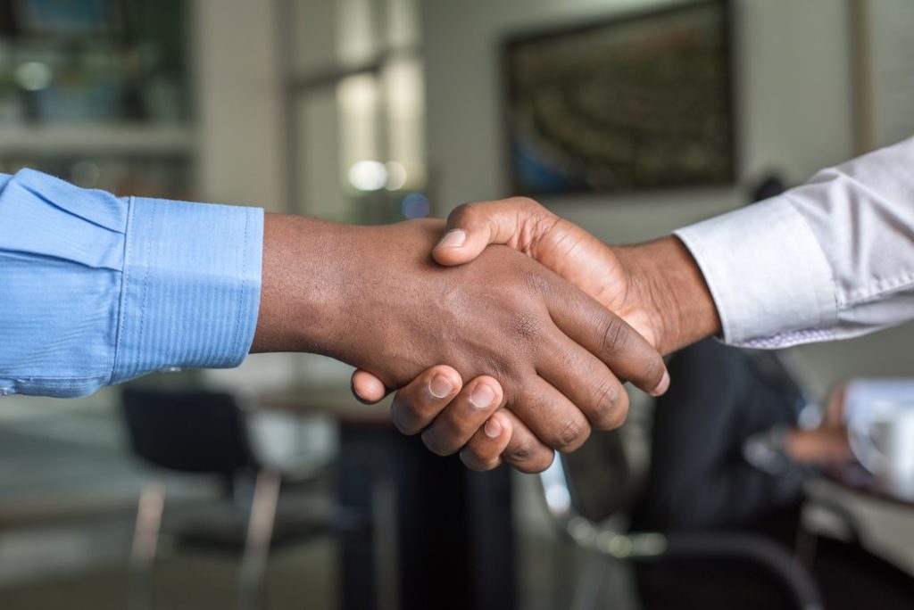 Two People Shaking Hands for an Agreement | Breast Cancer Car Donations