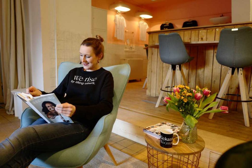 Woman Reading a Book at a Local Shop | Breast Cancer Car Donations