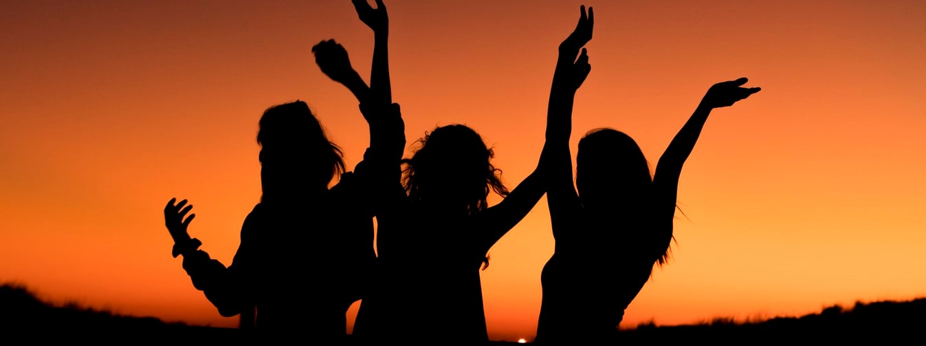 Women Celebrating at Sunset | Breast Cancer Car Donations