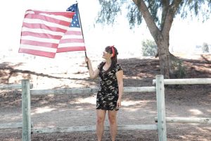 Woman Raising the US Flag | Breast Cancer Car Donations