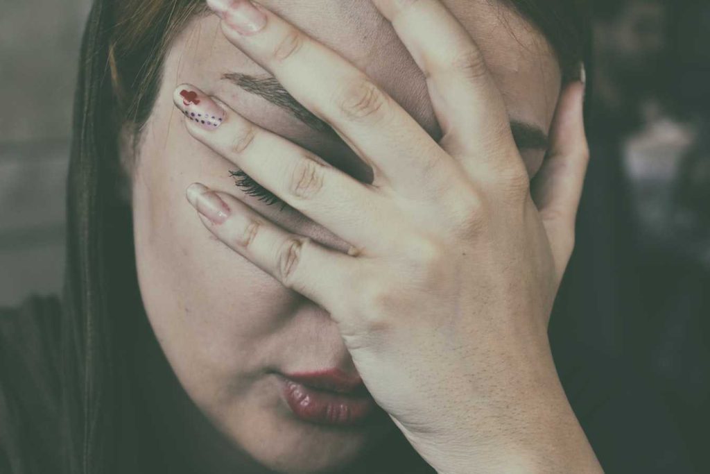 Woman's Hand on Face | Breast Cancer Car Donations