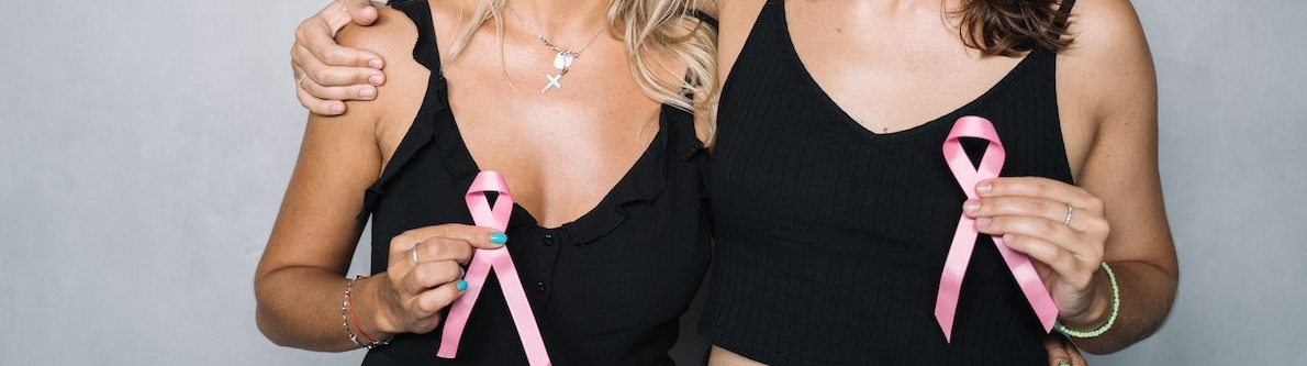 Two woman with pink ribbons | Breast Cancer Car Donations