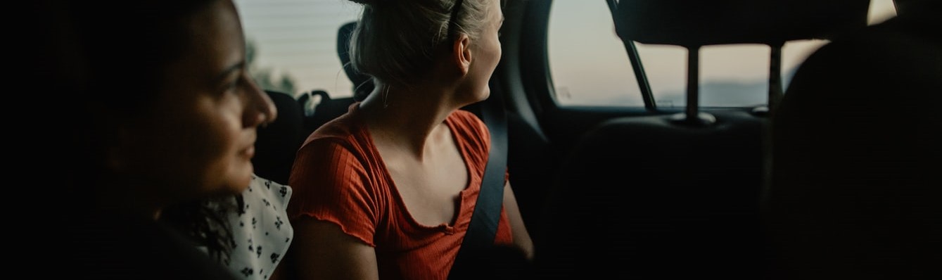 Woman Inside a Car Wearing Seatbelt | Breast Cancer Car Donations