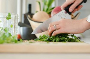 Woman Prepares Vegetable Dish | Breast Cancer Car Donations