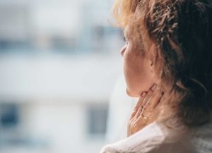 Worried Woman Looking Through Window | Breast Cancer Car Donations