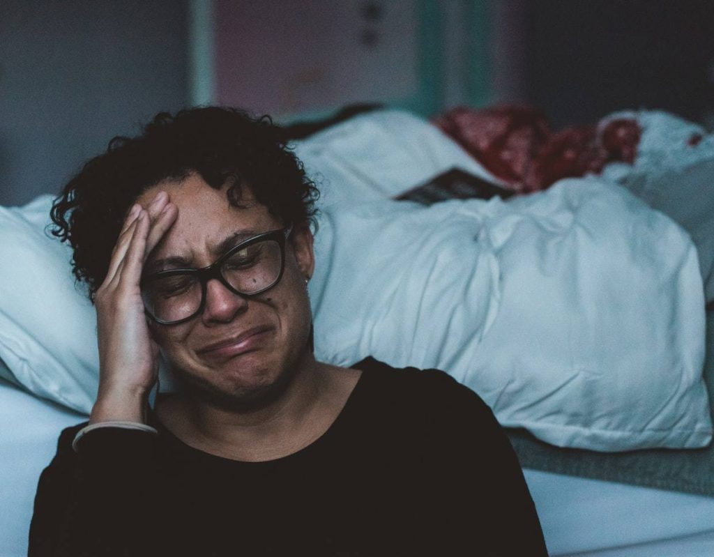 Grieving Woman in Bed | Breast Cancer Car Donations