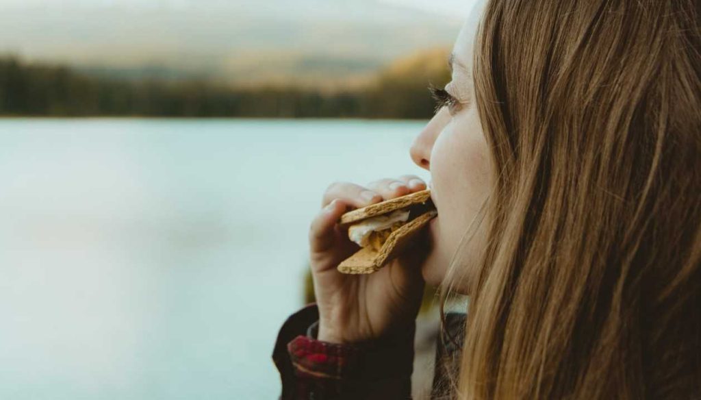 Woman Enjoying a Smore | Breast Cancer Car Donations