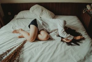 Troubled Person on a Bed | Breast Cancer Car Donations