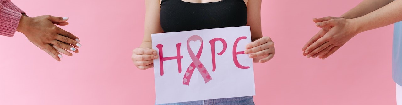 Woman Holding Breast Cancer Awareness Placard | Breast Cancer Car Donations