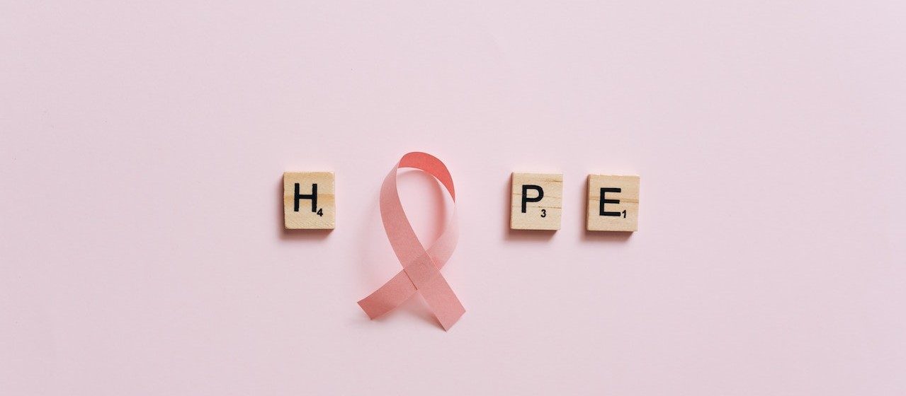 A Pink Ribbon on a Pink Surface with Message | Breast Cancer Car Donations