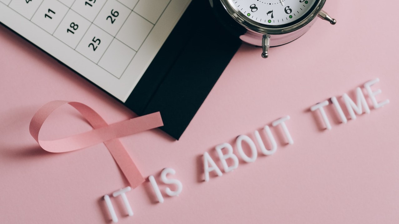 Close-Up Shot of a Pink Ribbon beside a Calendar | Breast Cancer Car Donations