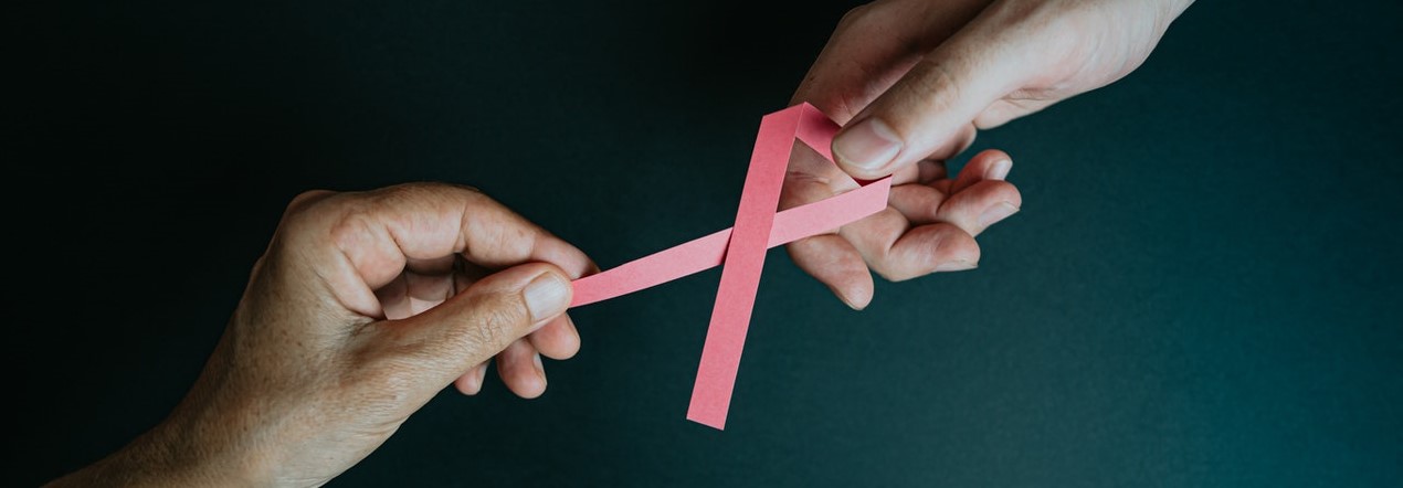 People Holding Pink Ribbon | Breast Cancer Car Donations