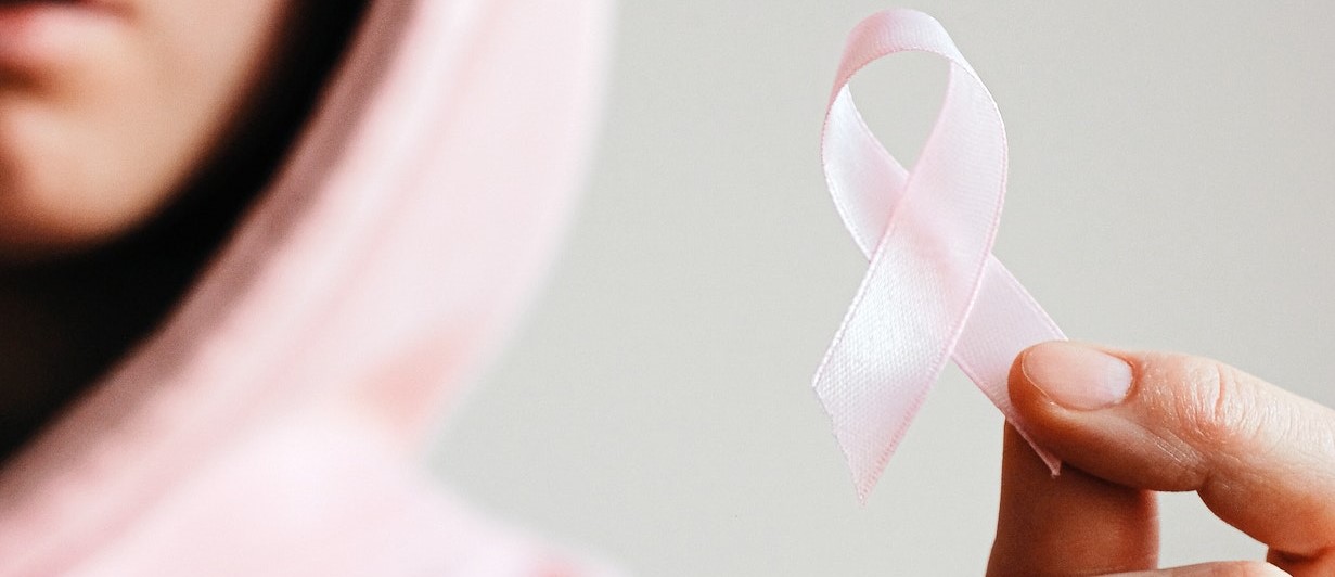 Person Holding a Pink Ribbon | Breast Cancer Car Donations