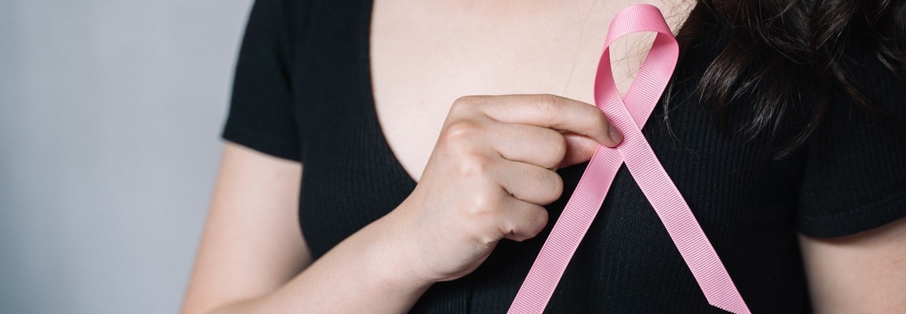 Woman Holding Pink Ribbon | Breast Cancer Car Donations