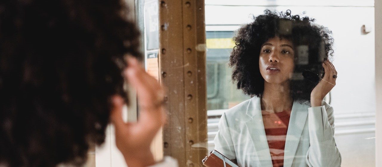 Woman in White Blazer in Front of Mirror | Breast Cancer Car Donations