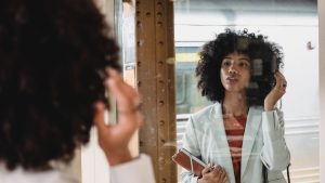 Woman in White Blazer in Front of Mirror | Breast Cancer Car Donations