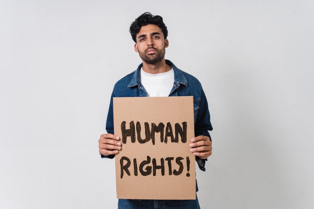 Person Holding Human Rights Banner | Breast Cancer Car Donations