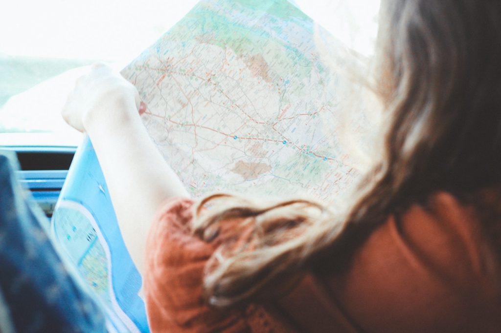 Woman Holding a Map on Travel | Breast Cancer Car Donations