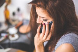 Woman Taking a Phone Call | Breast Cancer Car Donations