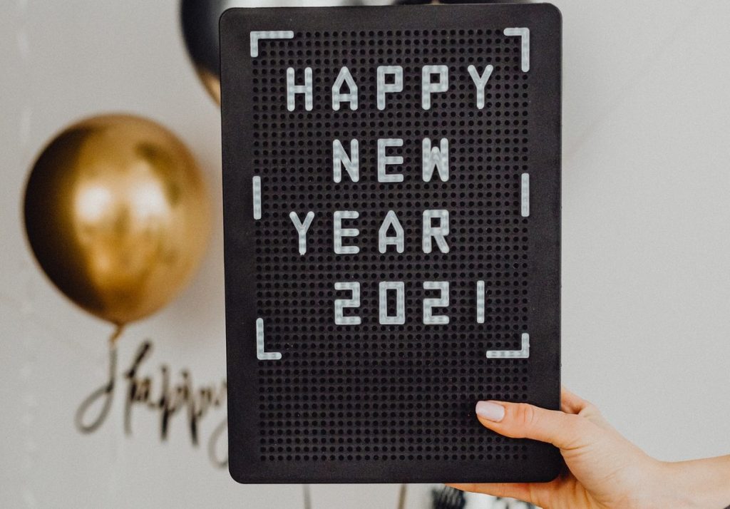 Person Holding A Happy New Year Text On A Black Board | Breast Cancer Car Donations