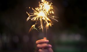 Person Holding Lighted Sparkler | Breast Cancer Car Donations