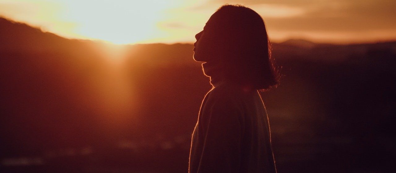 Silhouette Photography of Woman at Golden Hour | Breast Cancer Car Donations