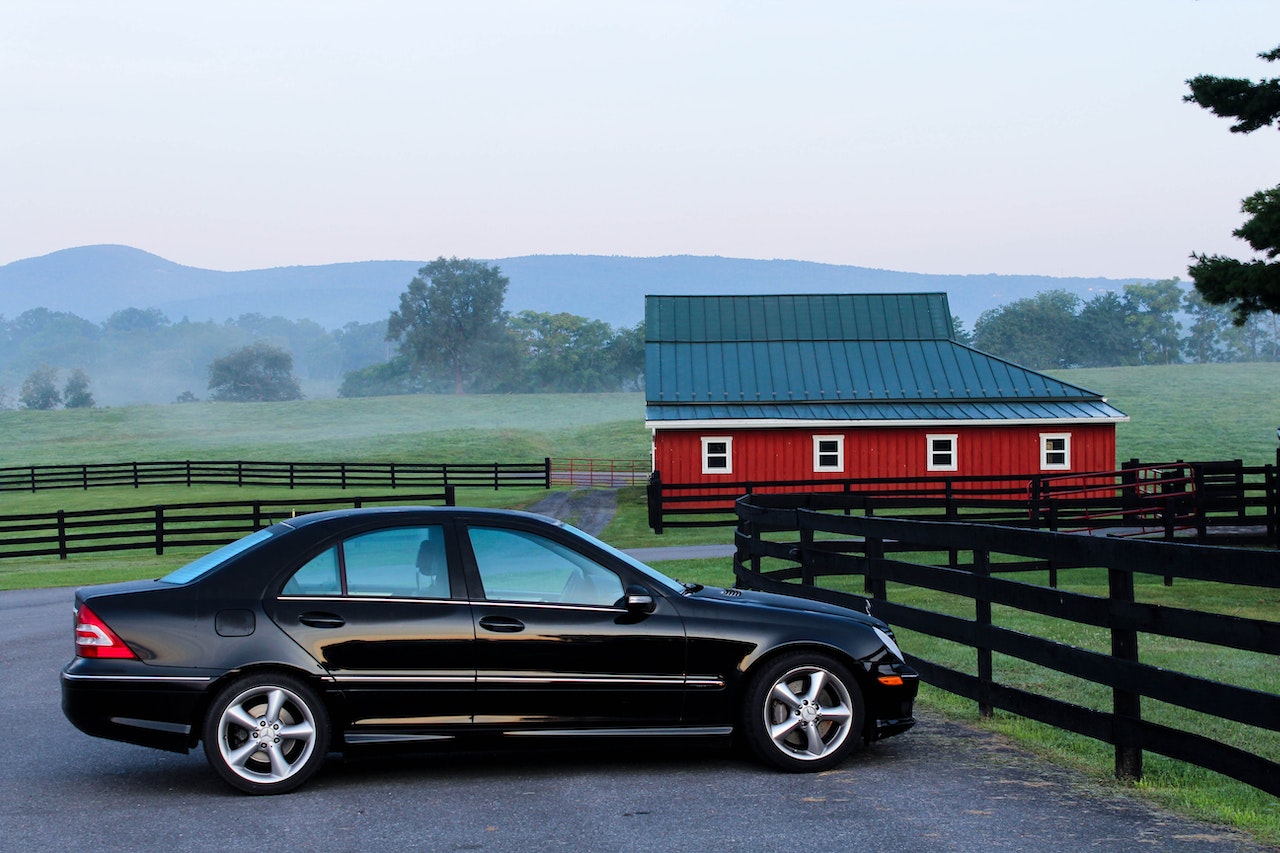 Black Coupe Near Black Wooden Fence during Daytime| Breast Cancer Car Donations