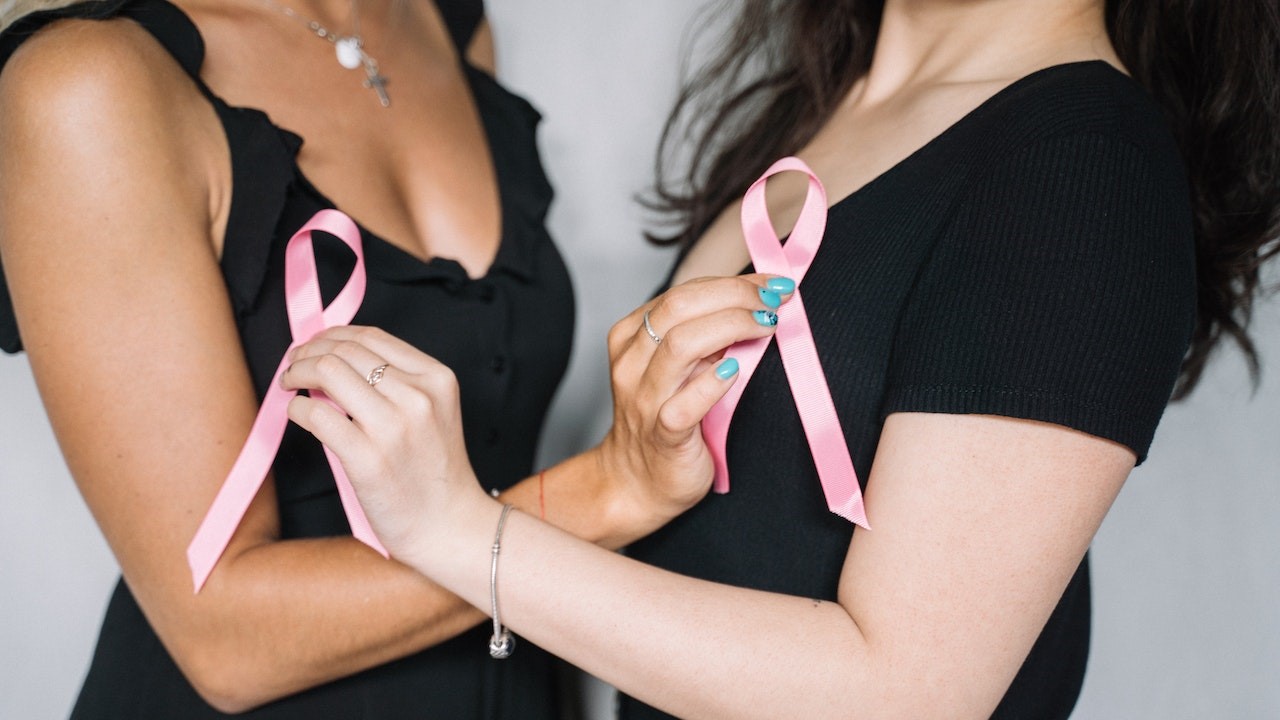 2 Women Holding Pink Ribbons | Breast Cancer Car Donations