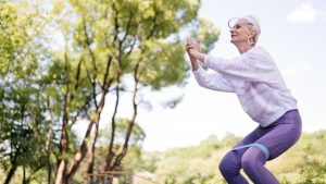 A Woman Working Out Using a Resistance Band | Breast Cancer Car Donations