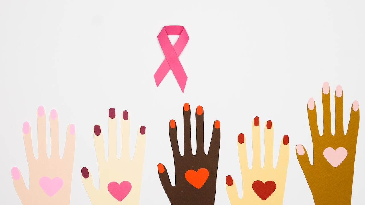 An Illustration of Hands with Heart Drawing Near Pink Ribbon | Breast Cancer Car Donations