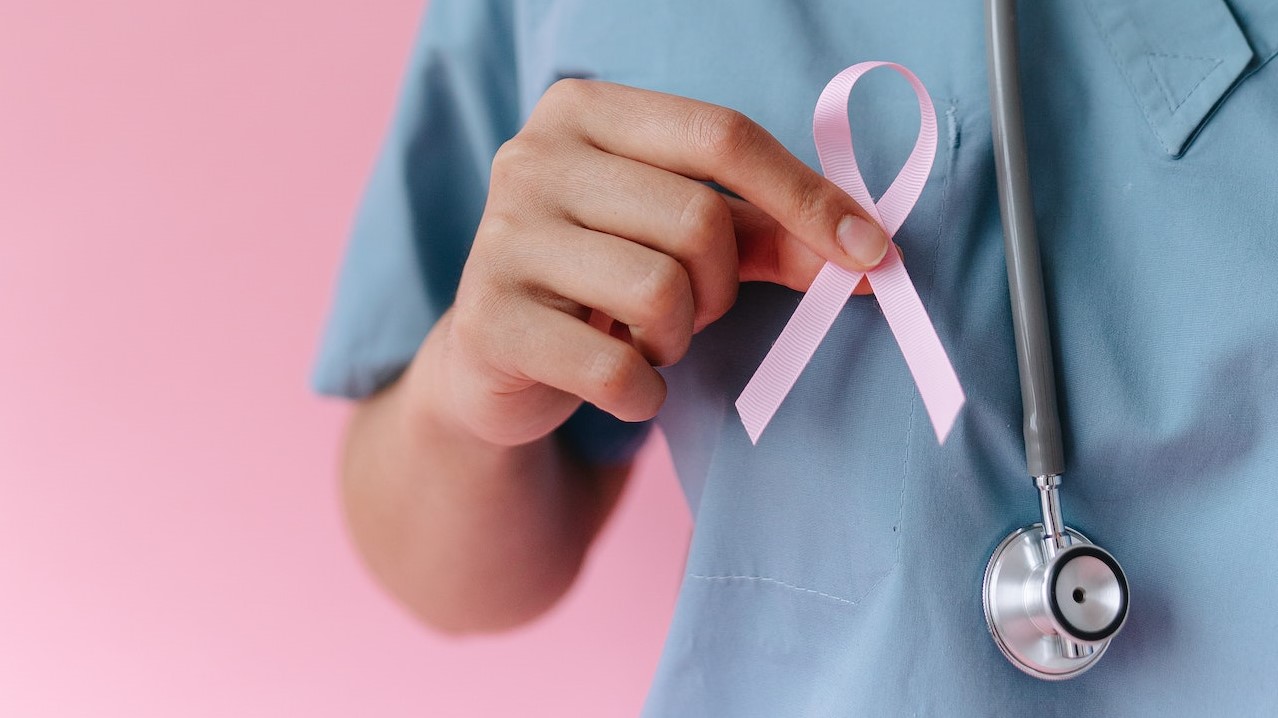 Medical Professional holding Pink Ribbon | Breast Cancer Car Donations