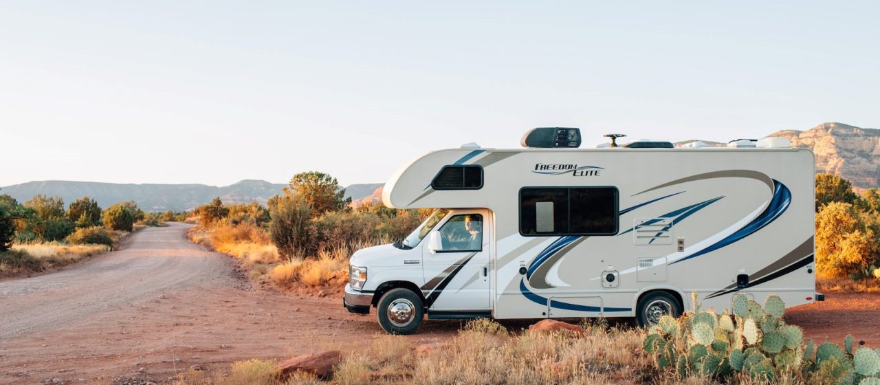 White and brown rv on brown grass | Breast Cancer Car Donations