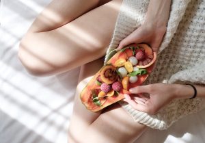 Woman Holding Assorted Fruits | Breast Cancer Car Donations
