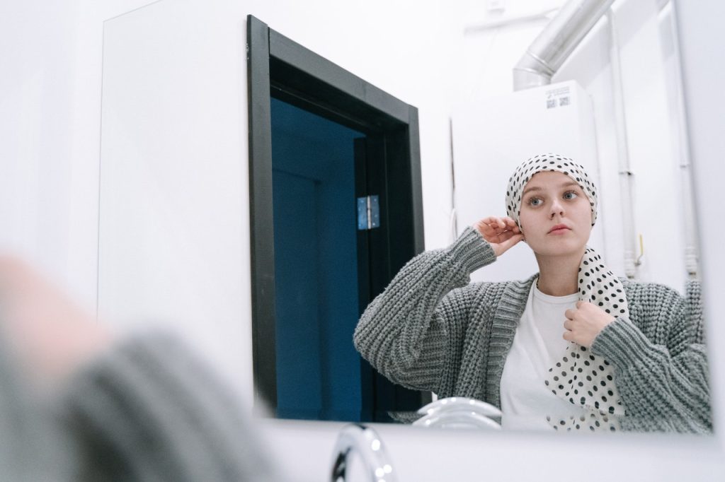 Breast Cancer Patient Looking at the Mirror | Breast Cancer Car Donations