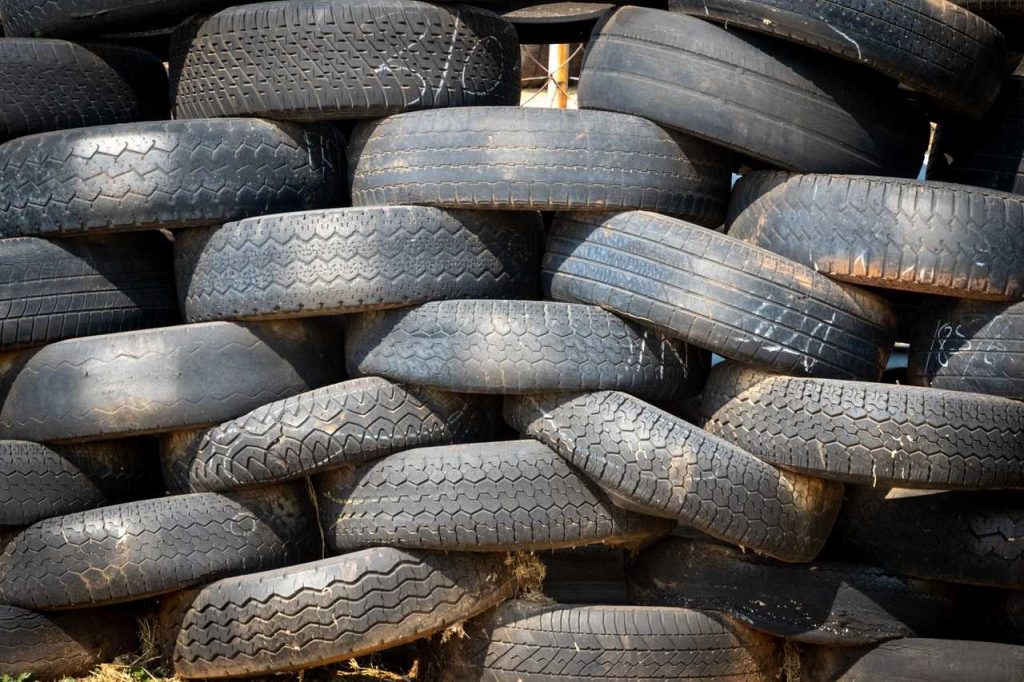 Old Car Tires Piled Up | Breast Cancer Car Donations