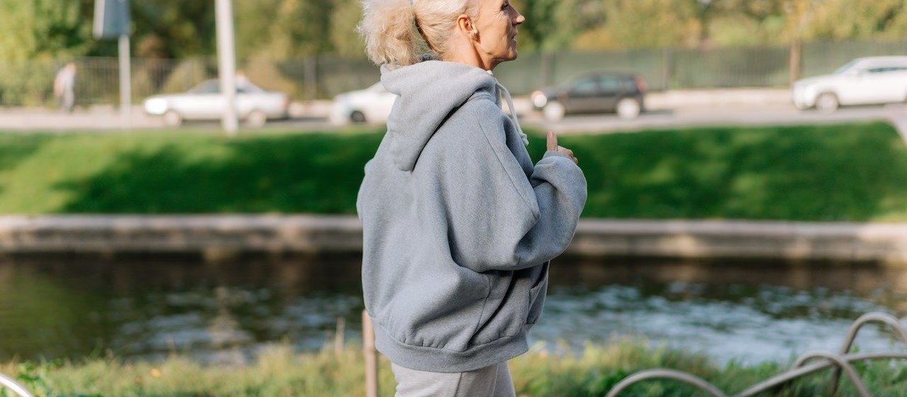Woman in Gray Hoodie Sweater Jogging | Breast Cancer Car Donations