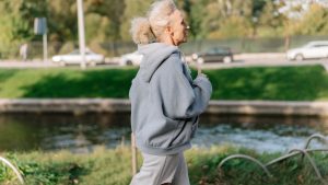 Woman in Gray Hoodie Sweater Jogging | Breast Cancer Car Donations