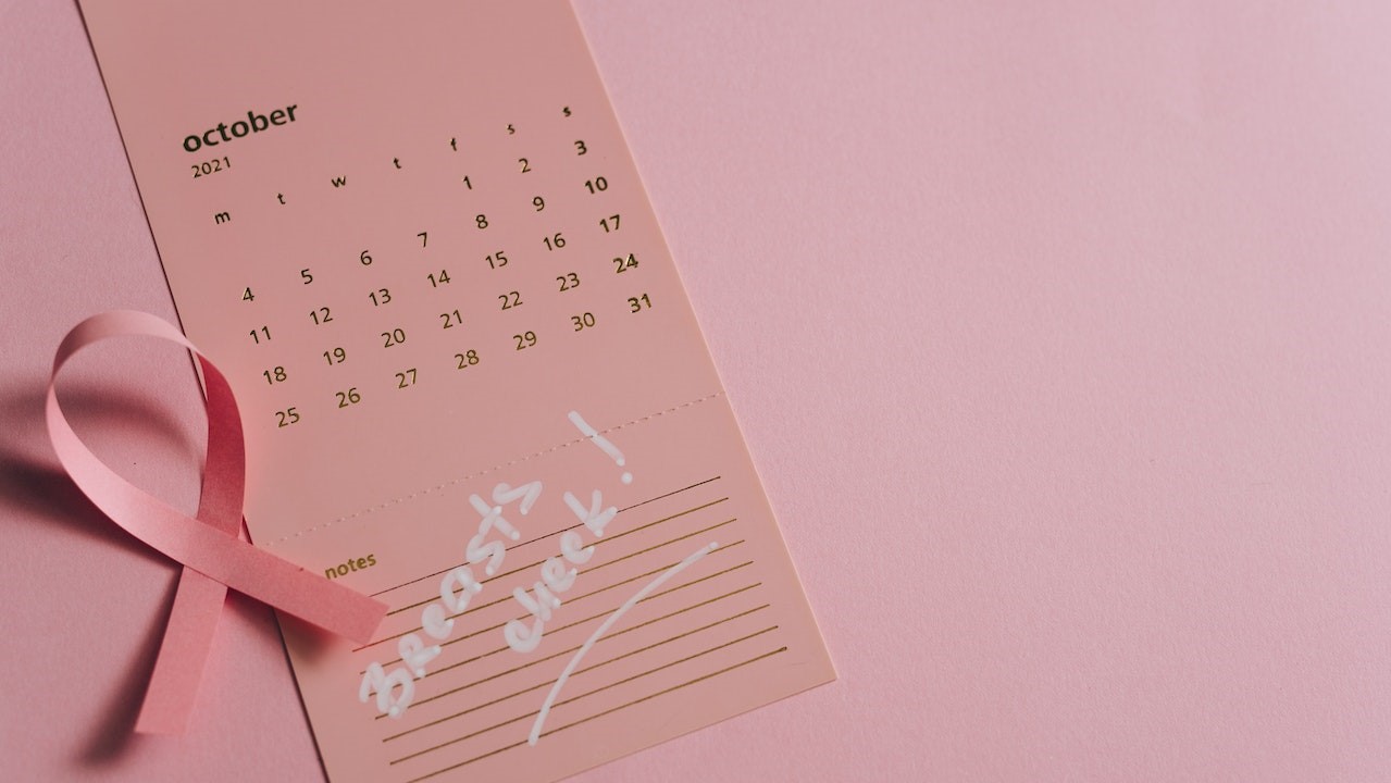 Close-Up Shot of a Pink Ribbon on a Calendar | Breast Cancer Car Donations