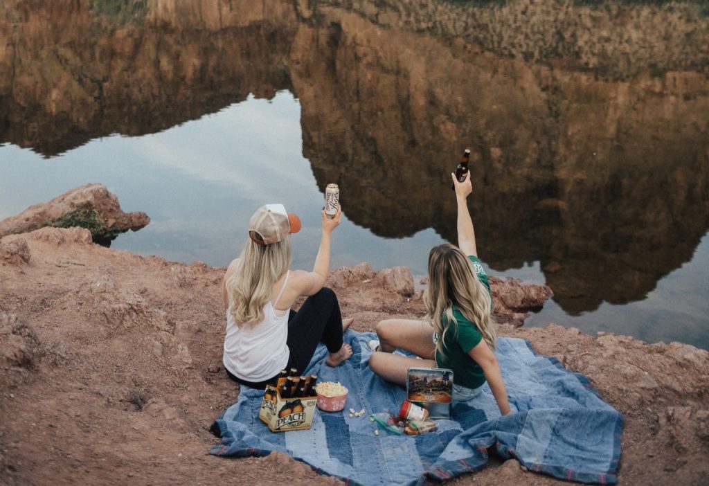 People Having Picnic on the Rocks | Breast Cancer Car Donations
