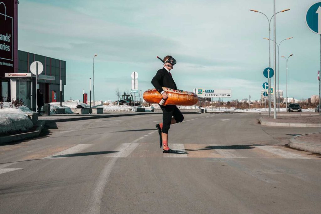 Strange man with swimming equipment on street | Breast Cancer Car Donations
