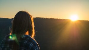 Woman Wearing Plaid Shirt Facing Sun during Golden Hour | Breast Cancer Car Donations