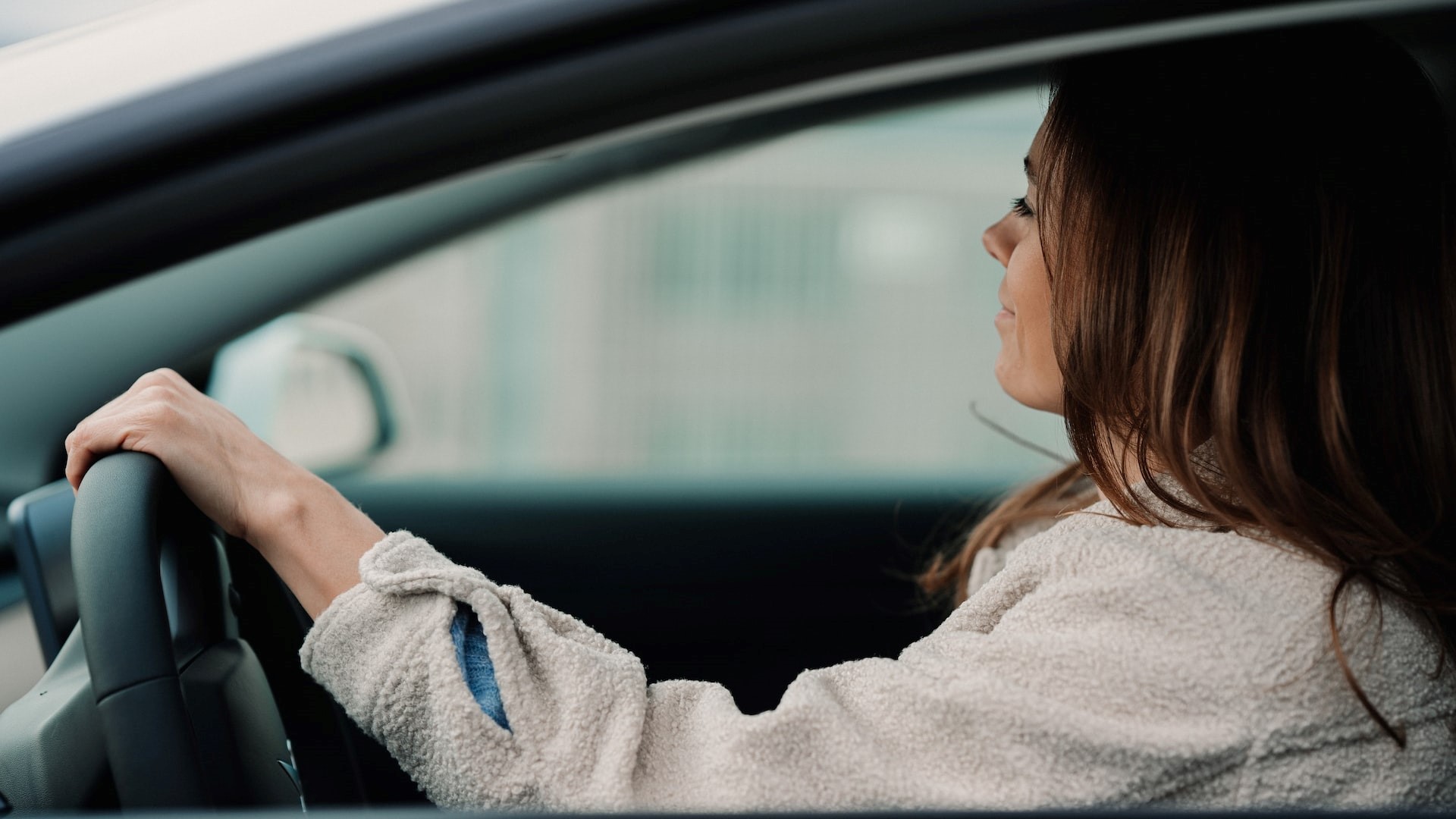 Jenny Ueberberg, female entrepreneur driving her Tesla Model 3 | Breast Cancer Car Donations