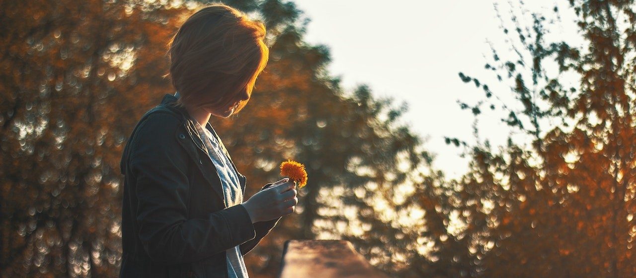 Selective Focus Photography of Woman Holding Petaled Flower | Breast Cancer Car Donations