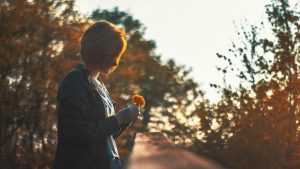 Selective Focus Photography of Woman Holding Petaled Flower | Breast Cancer Car Donations